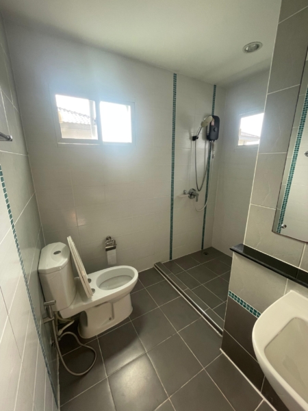 Modern, spacious bathroom with toilet, shower, and sink in a Thalang house for rent, pet-friendly.