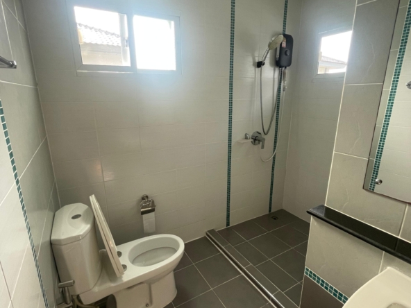 Modern, spacious bathroom with toilet, shower, and sink in a Thalang house for rent, pet-friendly.