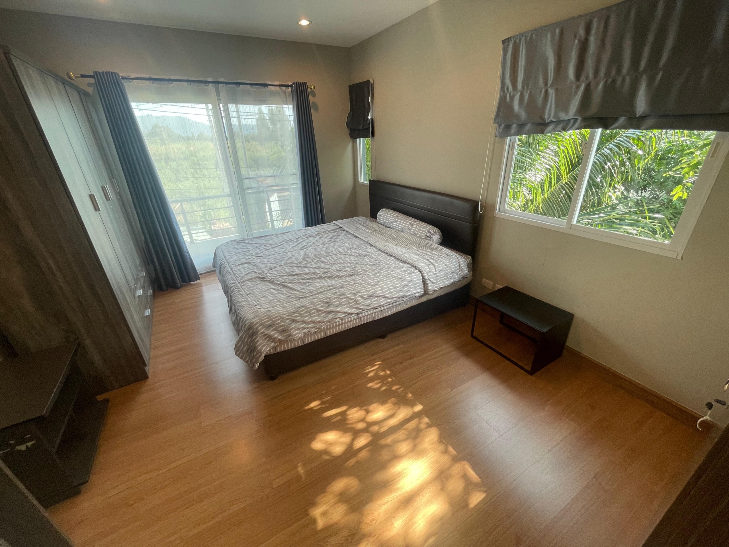 Spacious bedroom in a pet-friendly house for rent in Thalang with a lovely garden view.